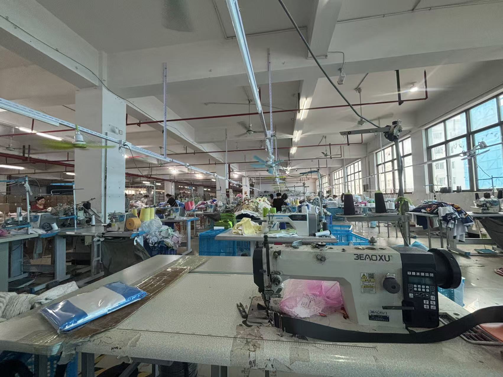 Towel sewing workshop with sewing machines and fabric production tables