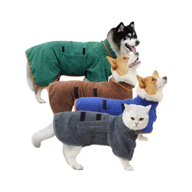 Dogs and a cat wearing green brown blue and gray wrap-style pet bathrobes on white