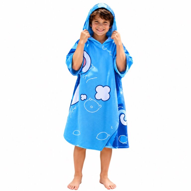 Boy wearing a blue printed hooded towel poncho on a white background