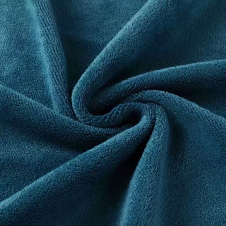 Dark teal microfiber velour fabric with soft pile and spiral folds