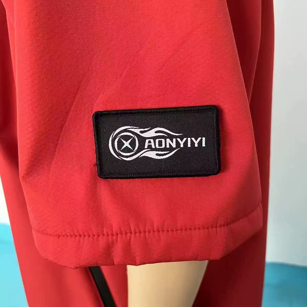 Woven brand patch on red robe fabric