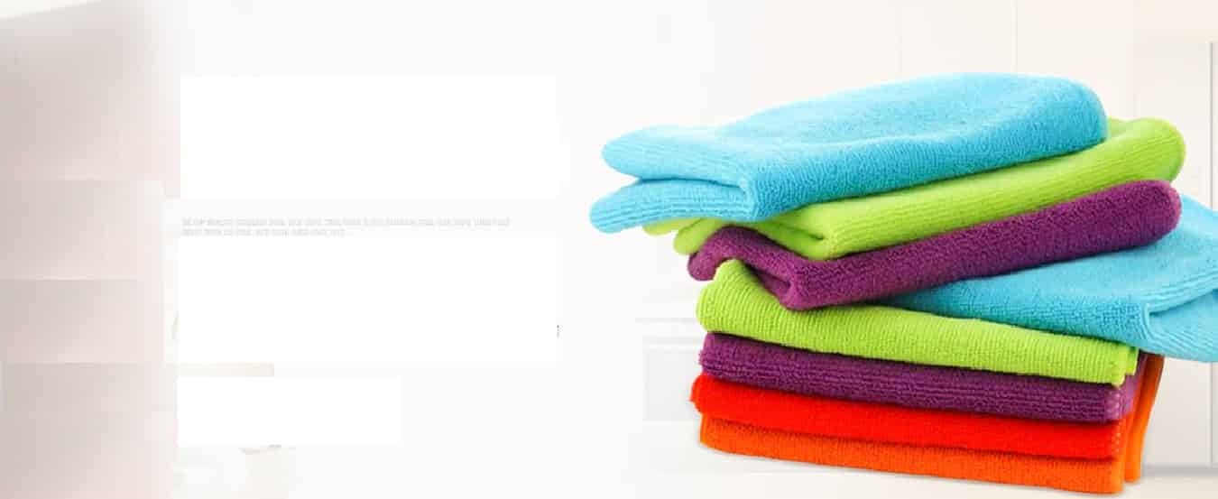 Stacked turquoise, lime green, purple and orange microfiber towels