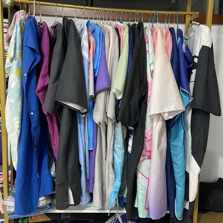 A selection of hooded towel ponchos displayed on a clothing rail