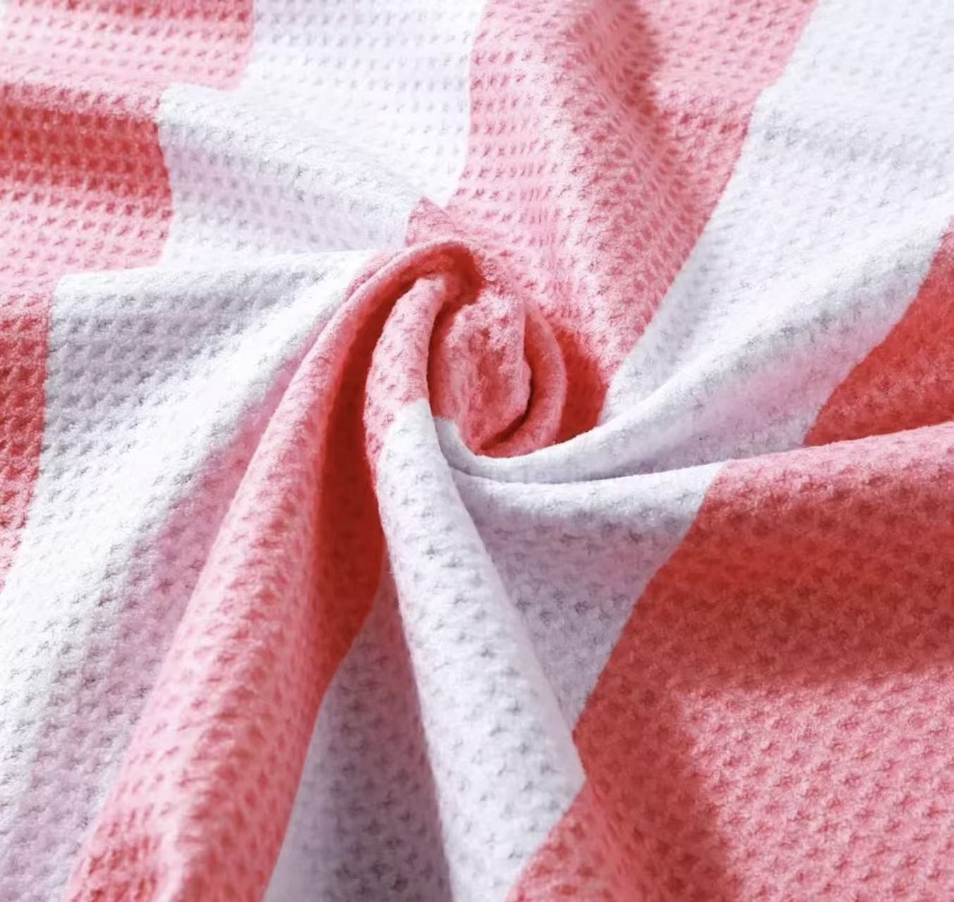 Close-up of pink and white microfiber waffle towel fabric