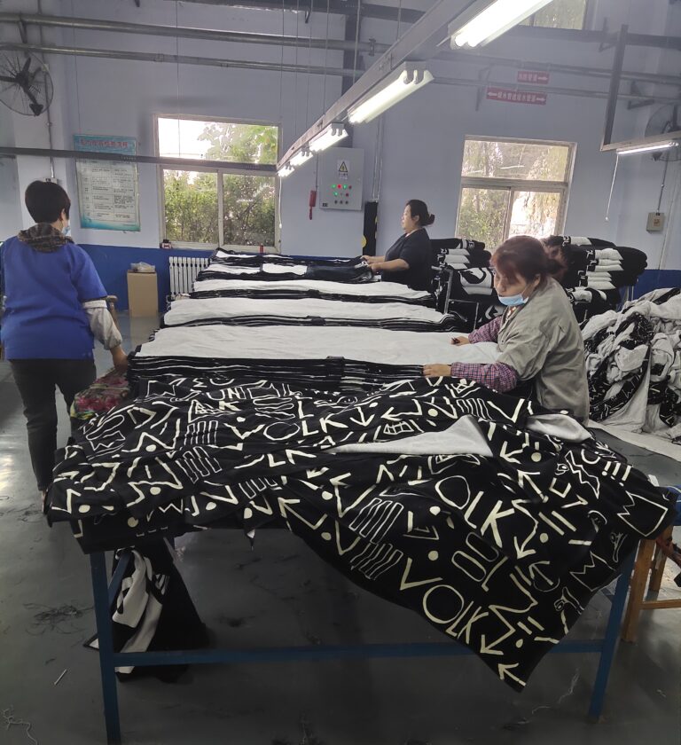 Workers inspecting printed towel fabric