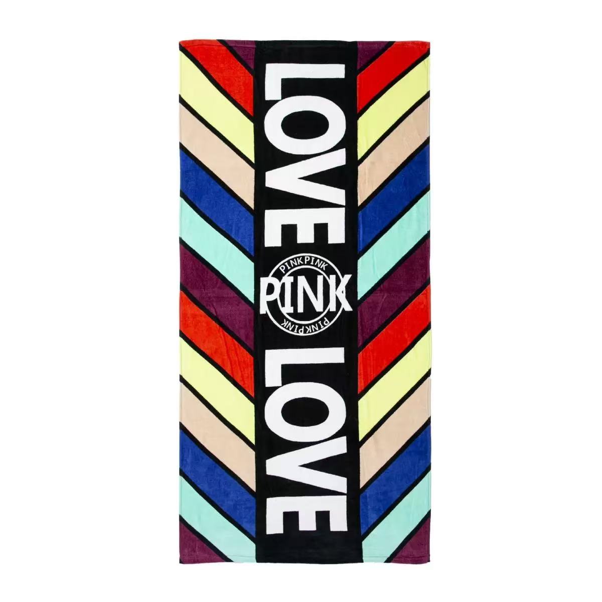 Colorful cotton beach towel with LOVE lettering and a PINK brand mark on white background