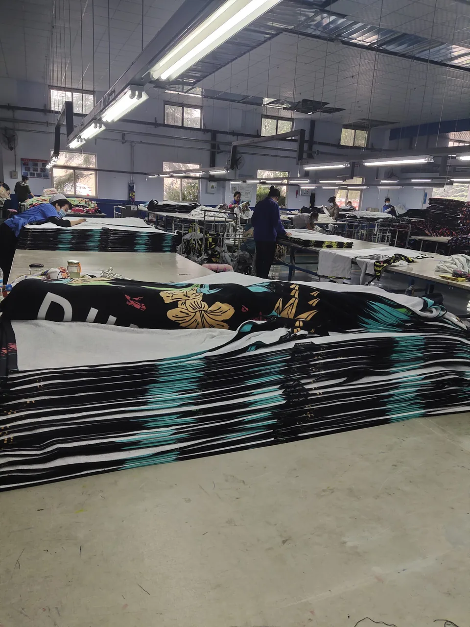 Workers handling printed towel fabric in Favor Houseware’s textile workshop