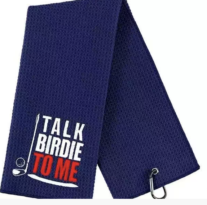 Navy embroidered golf towel with white and red lettering and a carabiner