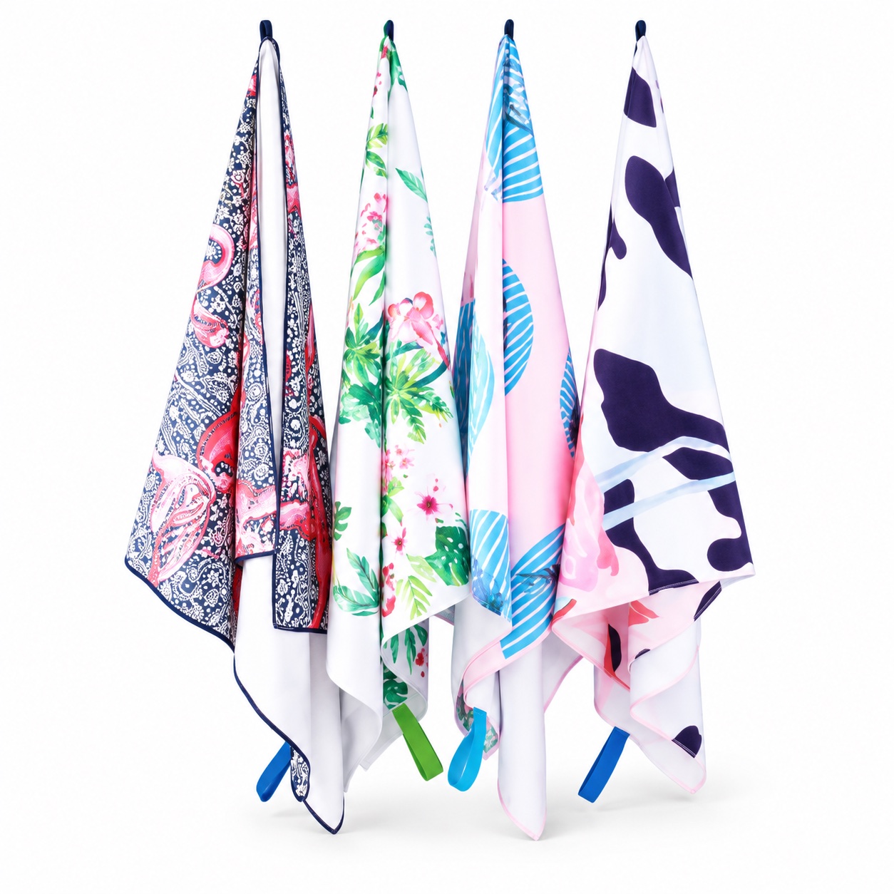 Four custom printed microfiber beach towels on a white background