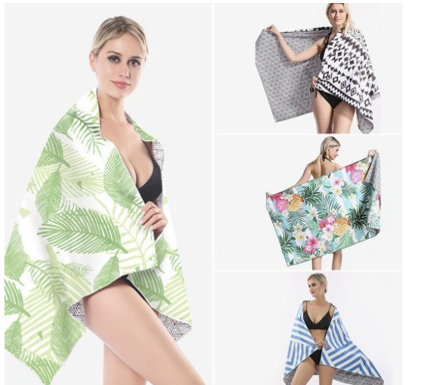Four examples of a model displaying different printed beach towel designs